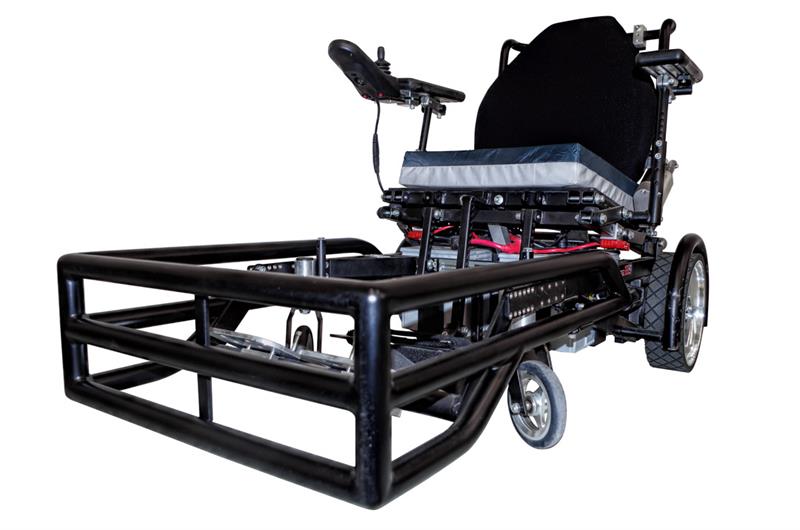 Strikeforce Chair. Black electric wheelchair with a protective bumper guard on the front and a cushioned seat.