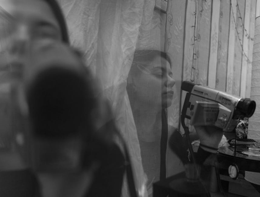 Focused young female filming video blog on camera