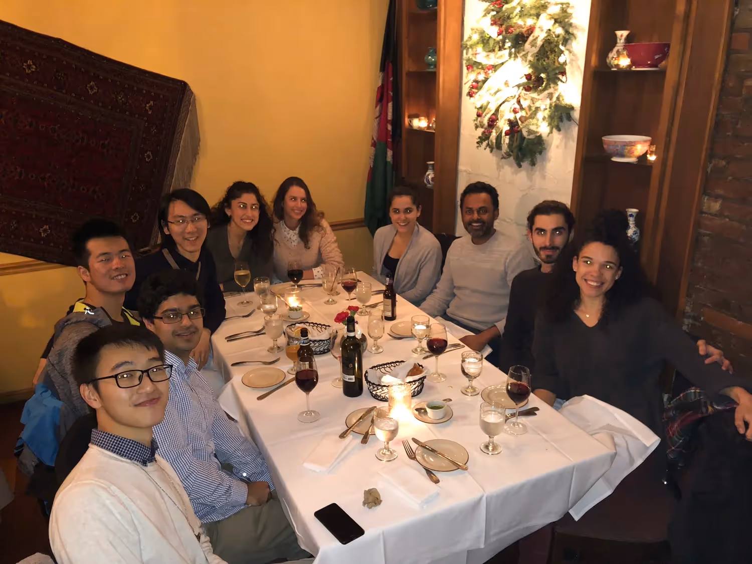Large group of lab members around a dinner table