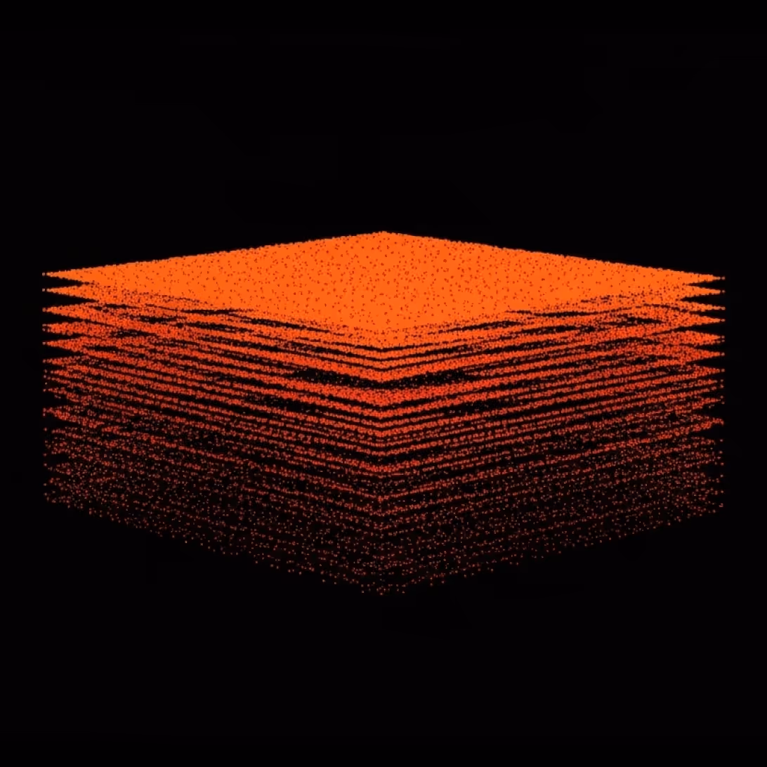 3D layered cube composed of tiny orange and red dots on a black background.