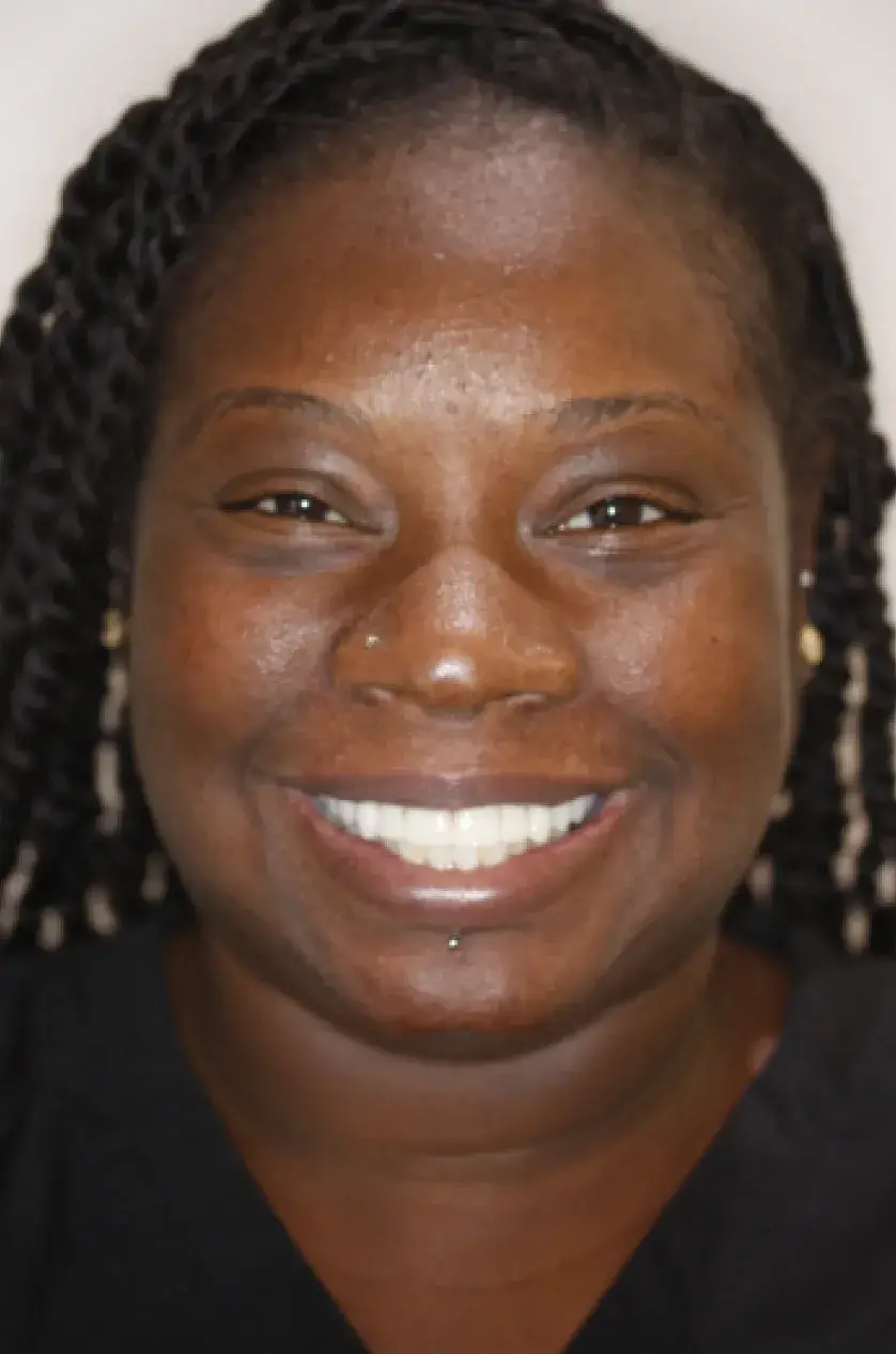 A person smiling widely at the camera.