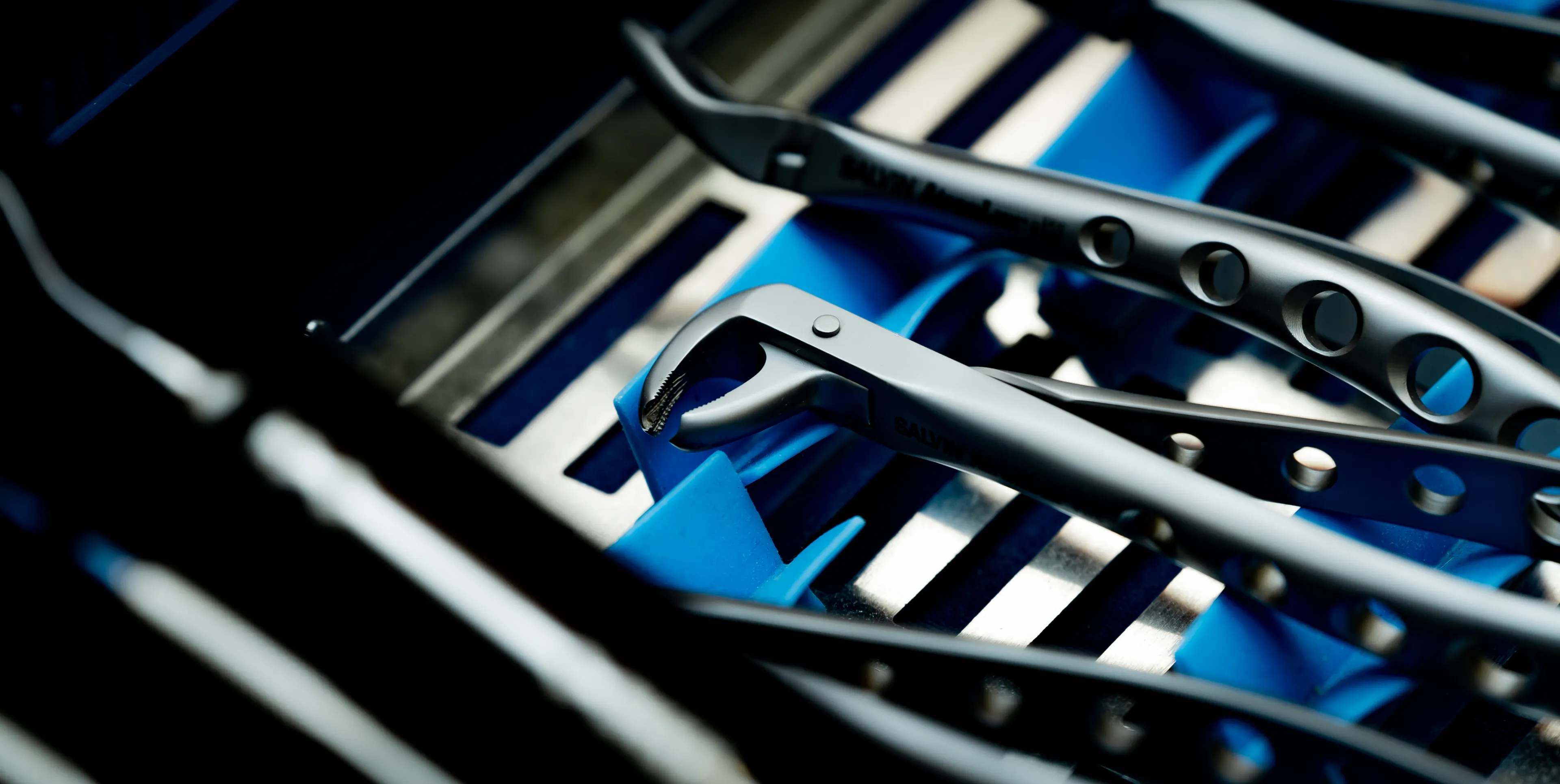 Metal surgical tools arranged neatly in a tray, ready for use.