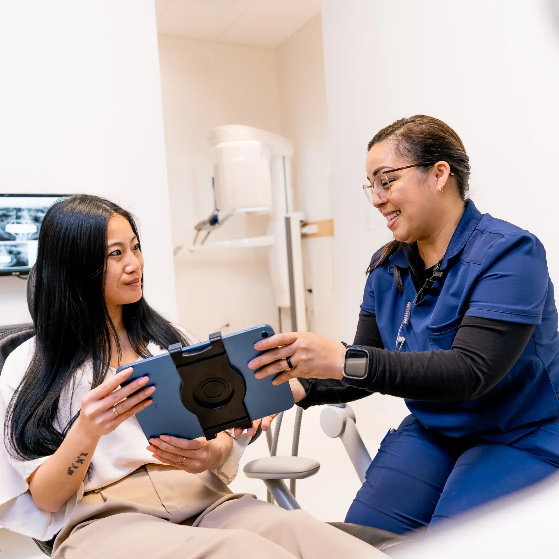 Team member handing a tablet to patient