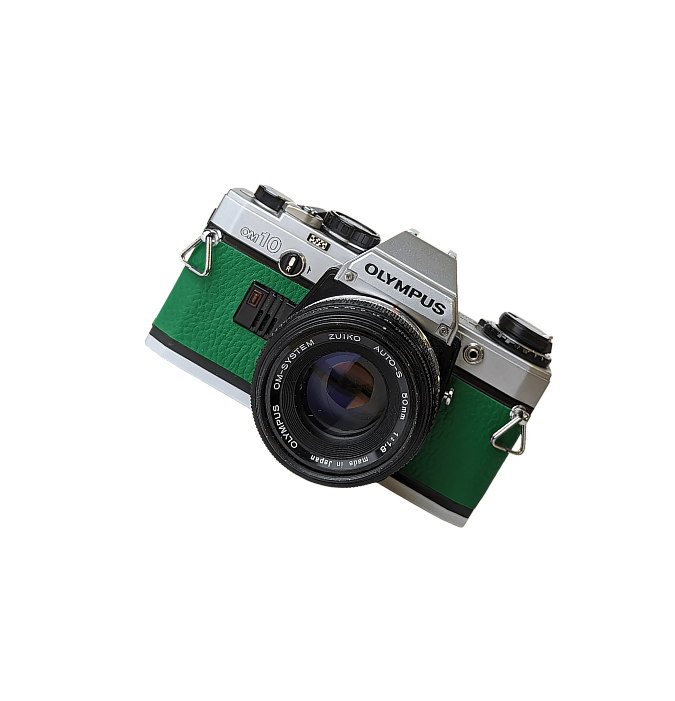 Retro Olympus OM-10 film camera with green leatherette body and attached 50mm Zuiko lens.