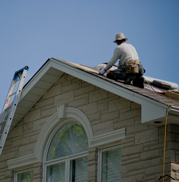 Roofer installing shingles on a residential roof