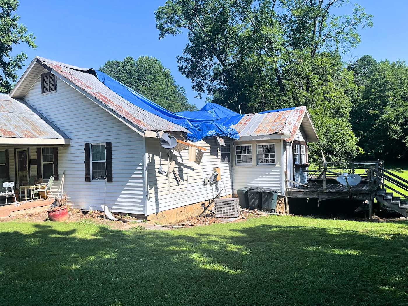 Roof with damage and tarp