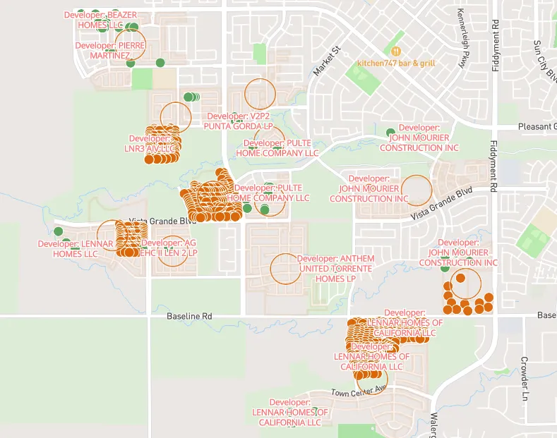 Map showing housing development projects in a suburban area with developer names and clustered orange property markers.