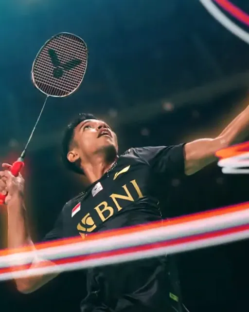 A young man wearing a grey hooded jacket.