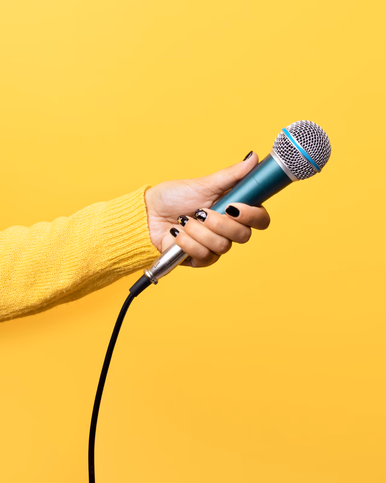 Hand holding microphone centered on yellow background|Hand holding microphone centered on yellow background|funny meme about speaking your mind at work