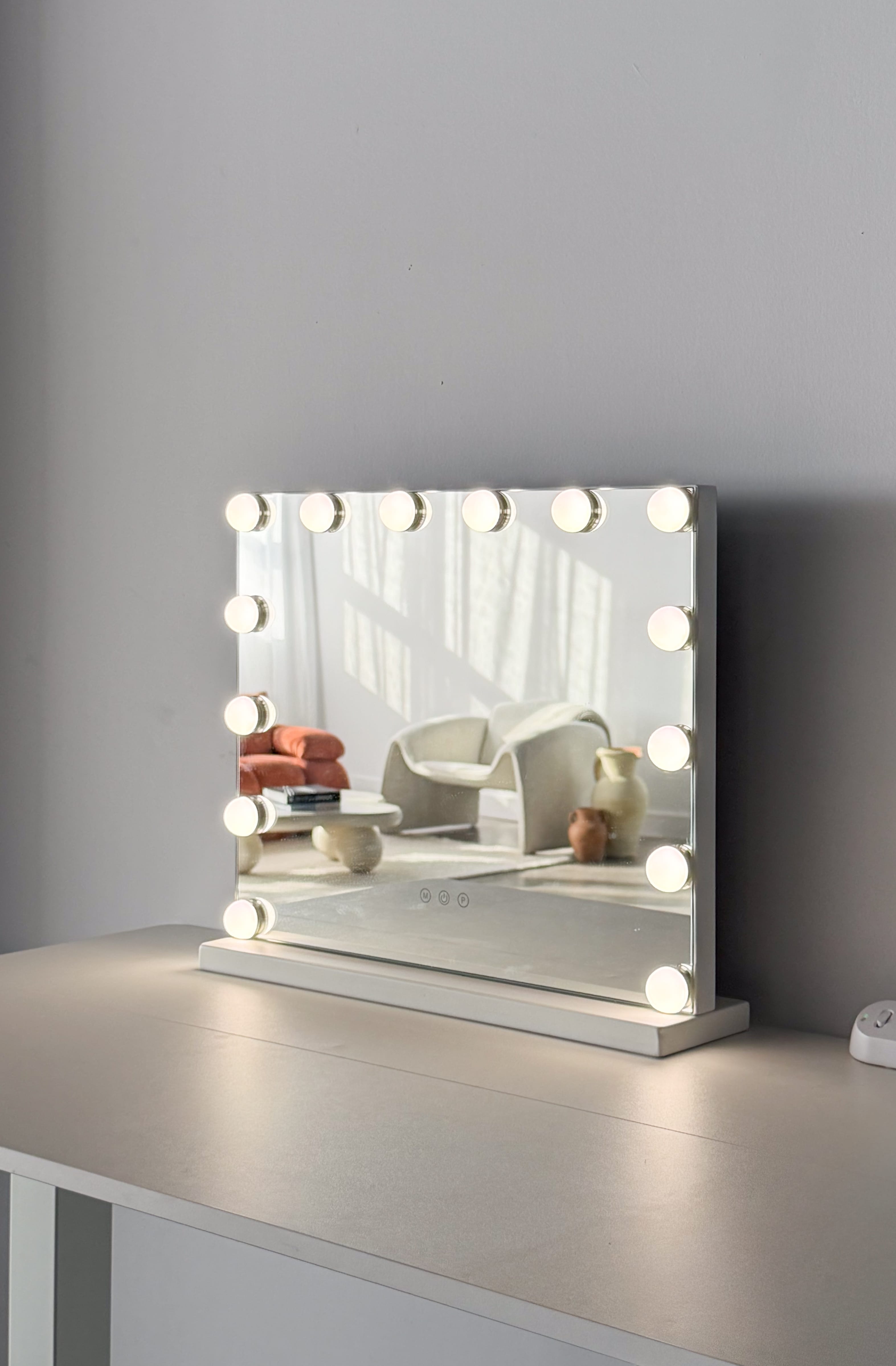 Two rustic ceramic jugs, one smaller and terracotta-colored, the other larger and off-white, standing on a tiled floor with soft natural light and shadows on a plain wall background.