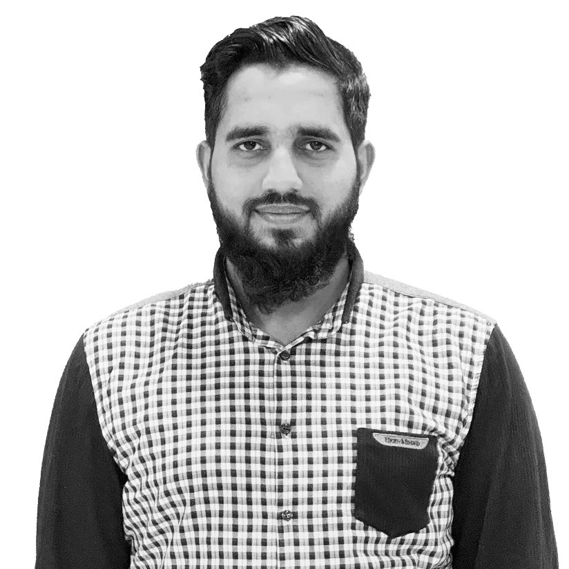 Man with short dark hair and beard wearing a checkered shirt with a dark pocket.