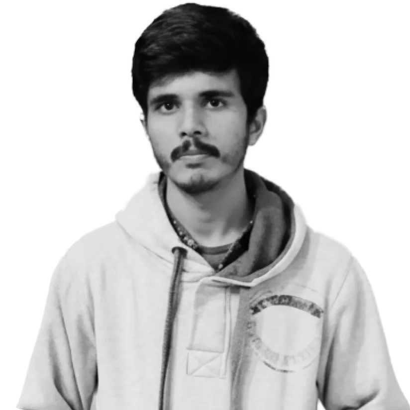 Portrait of a young man with short dark hair and a mustache, wearing a light-colored hoodie.