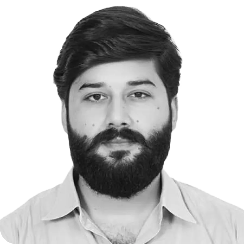 Portrait of a man with a full beard and mustache, wearing a collared shirt, looking straight ahead.