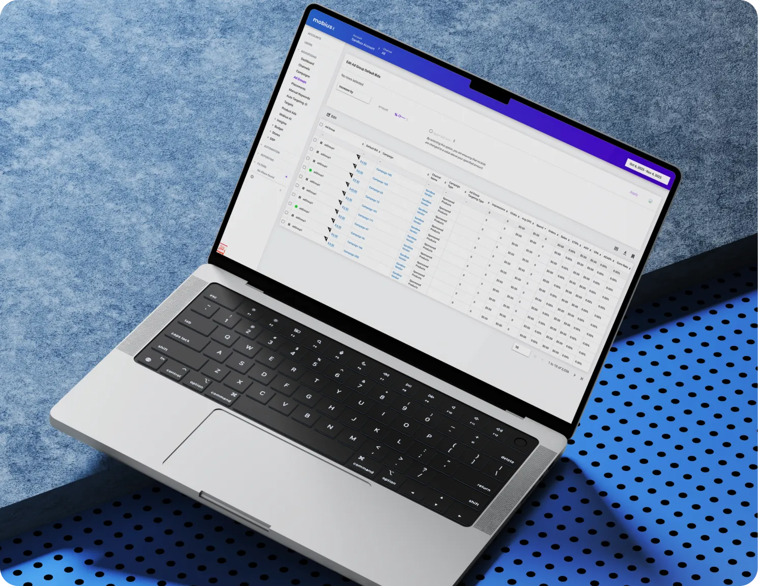 Laptop on blue textured surface displaying an analytics dashboard with tables and campaign data.