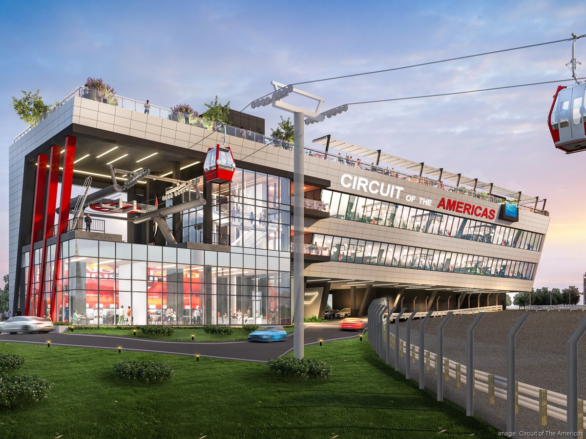 A hand holding a small vial over a robotic apparatus inside a laboratory setup, with visible mechanical components in the background.