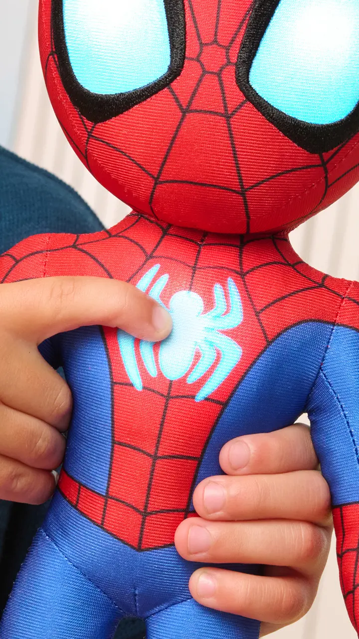 Child playing with Spidey plush toy from Marvel Spidey and His Amazing Friends