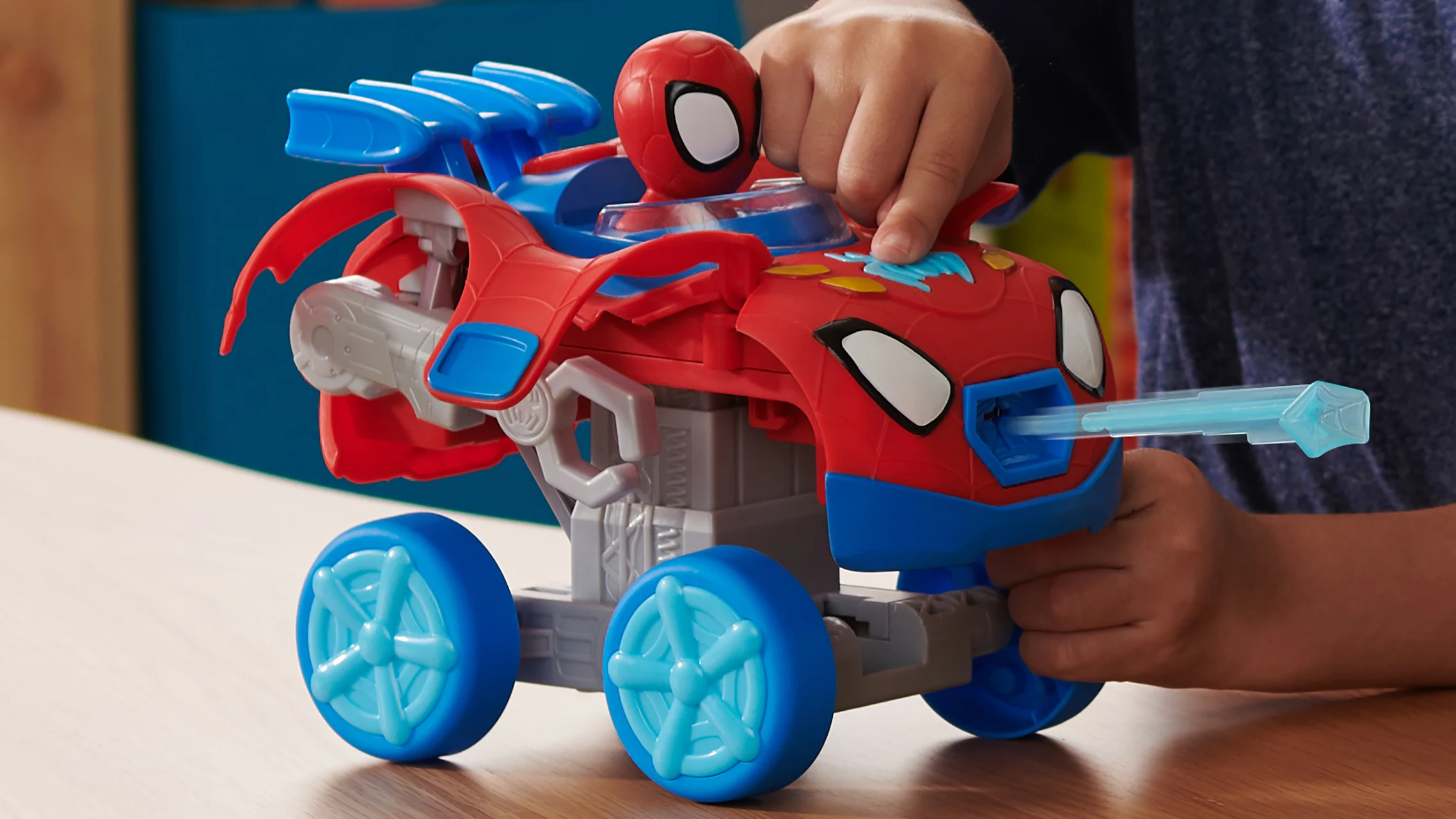 Child playing with a Spidey themed toy vehicle from Marvel Spidey and His Amazing Friends