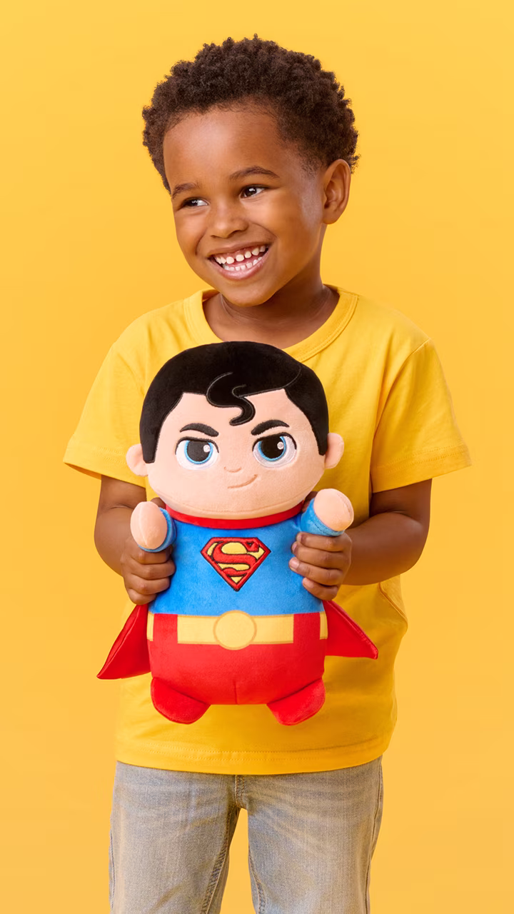 Child hugging a HugMees Squishmallows plush toy