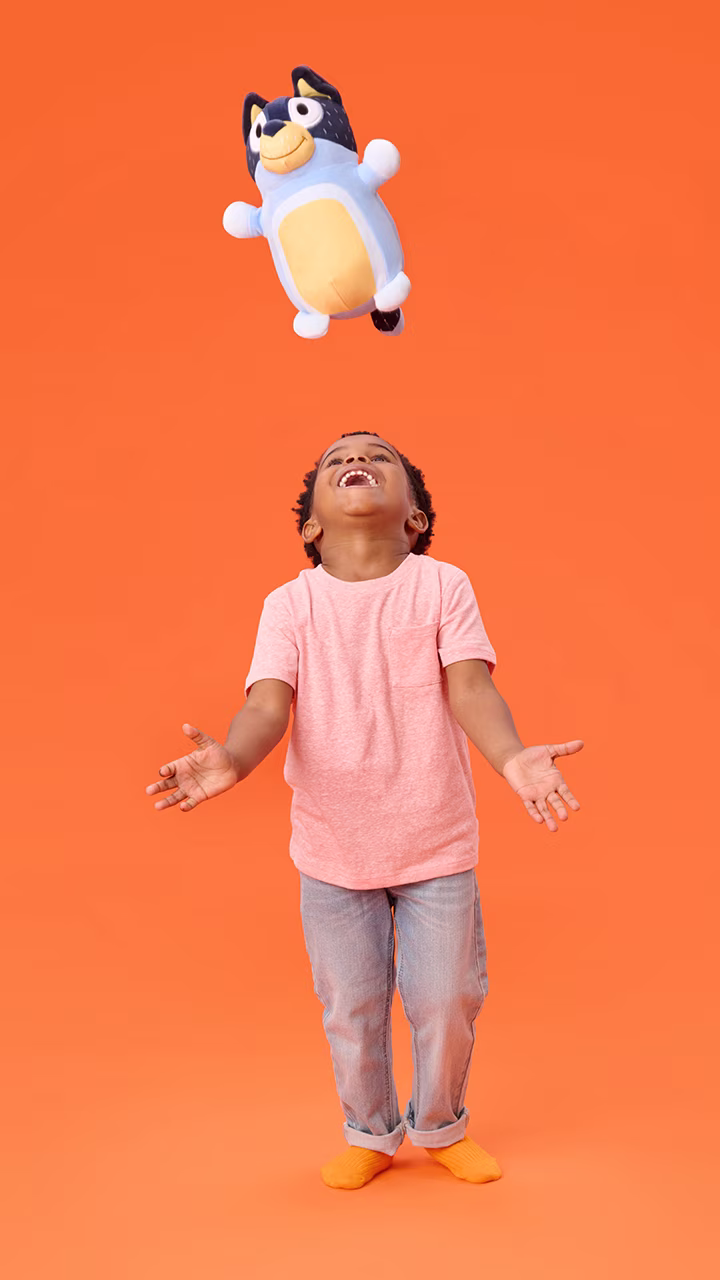 Child hugging a soft HugMees Squishmallows plush character