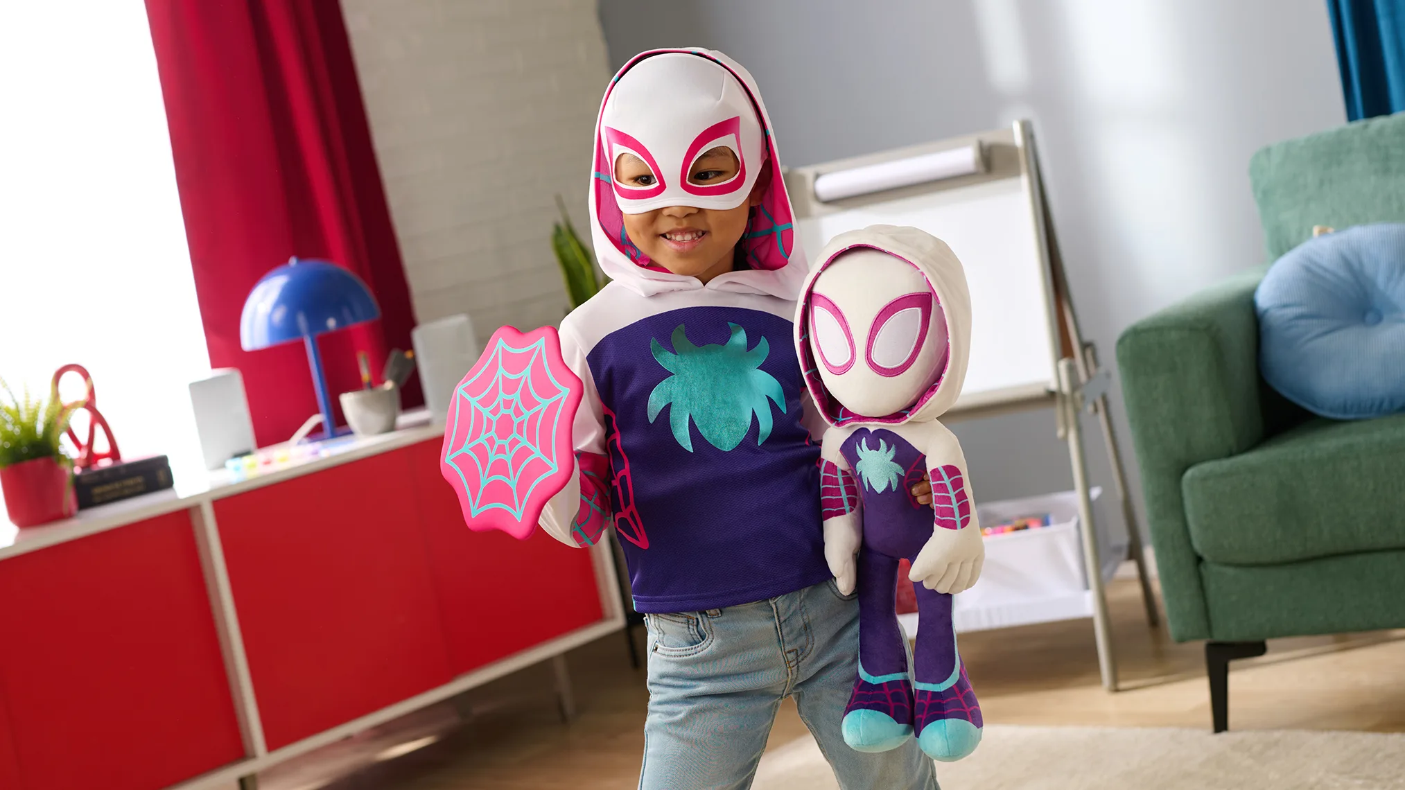 Child dressed as Spider-Gwen holding a Spider-Gwen plush toy and web shield