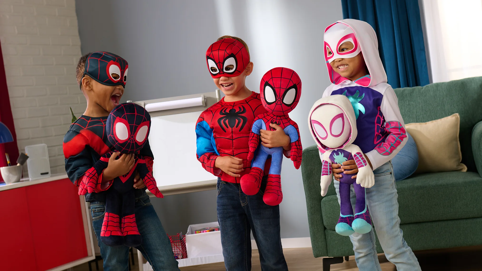 Three children in Spider-Man themed costumes holding superhero plush toys