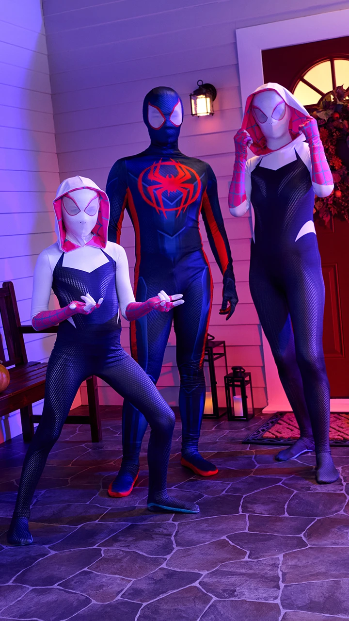 Group of children dressed as Spider-Man characters playing together
