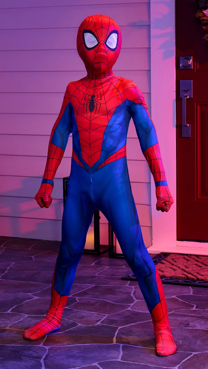 Child wearing a Spider-Man costume standing in a playful hero pose