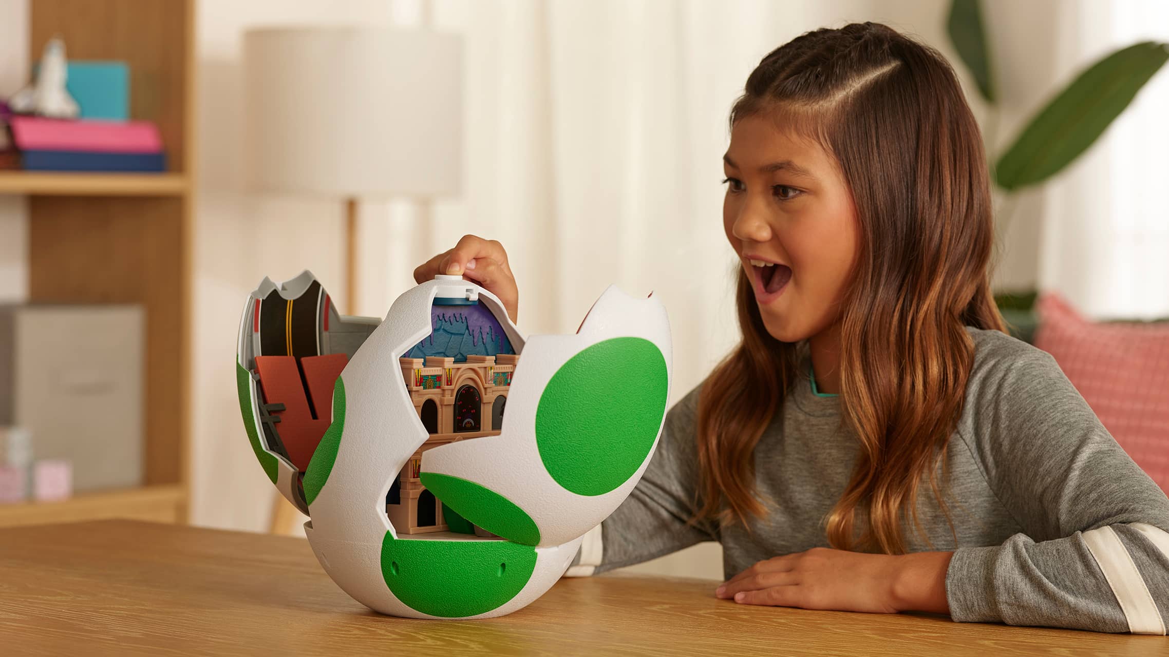 Child opening Super Mario Yoshi egg playset to reveal hidden interior scene