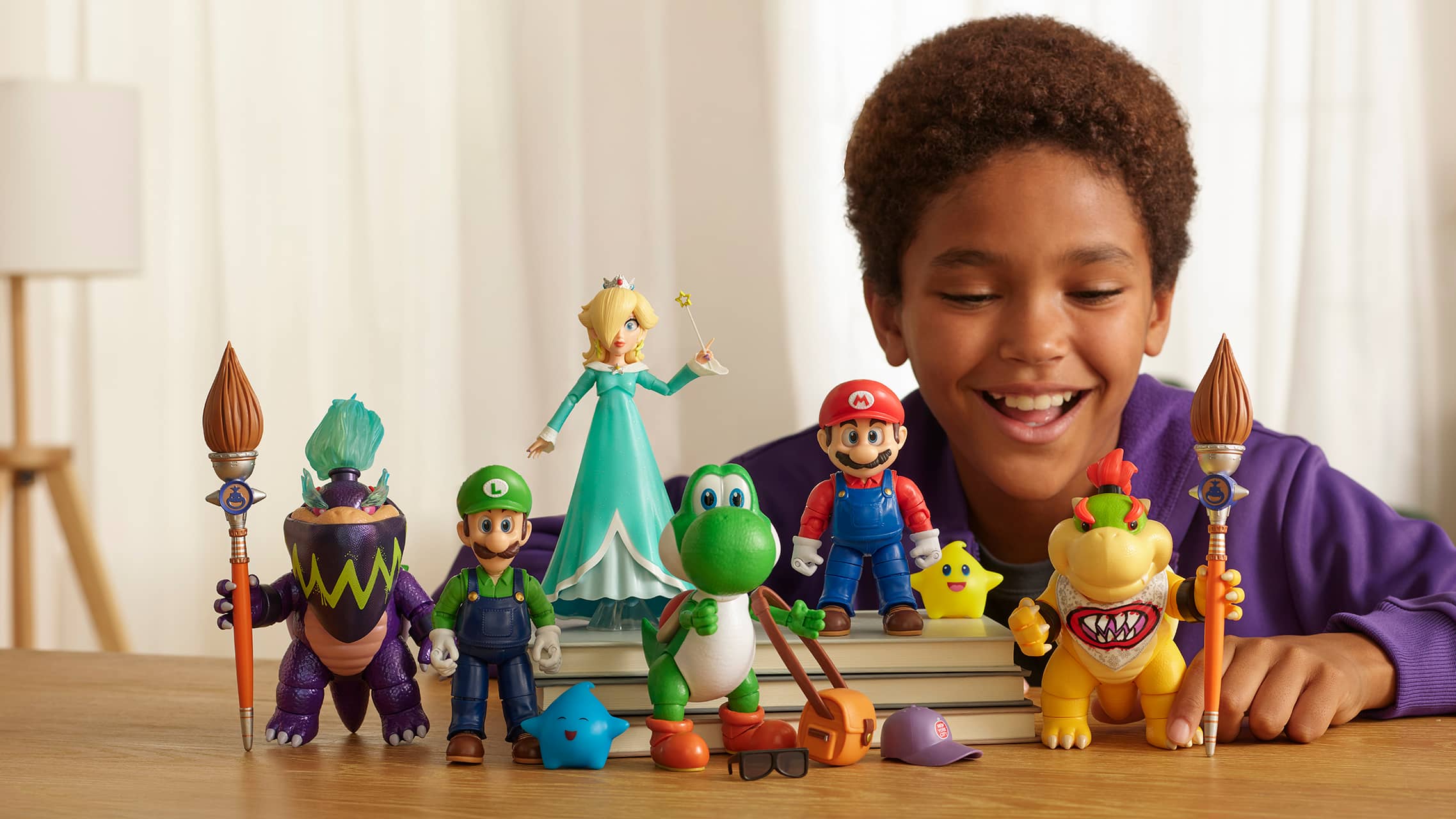 Child playing with Super Mario character figures including Luigi, Yoshi, Rosalina, and Bowser