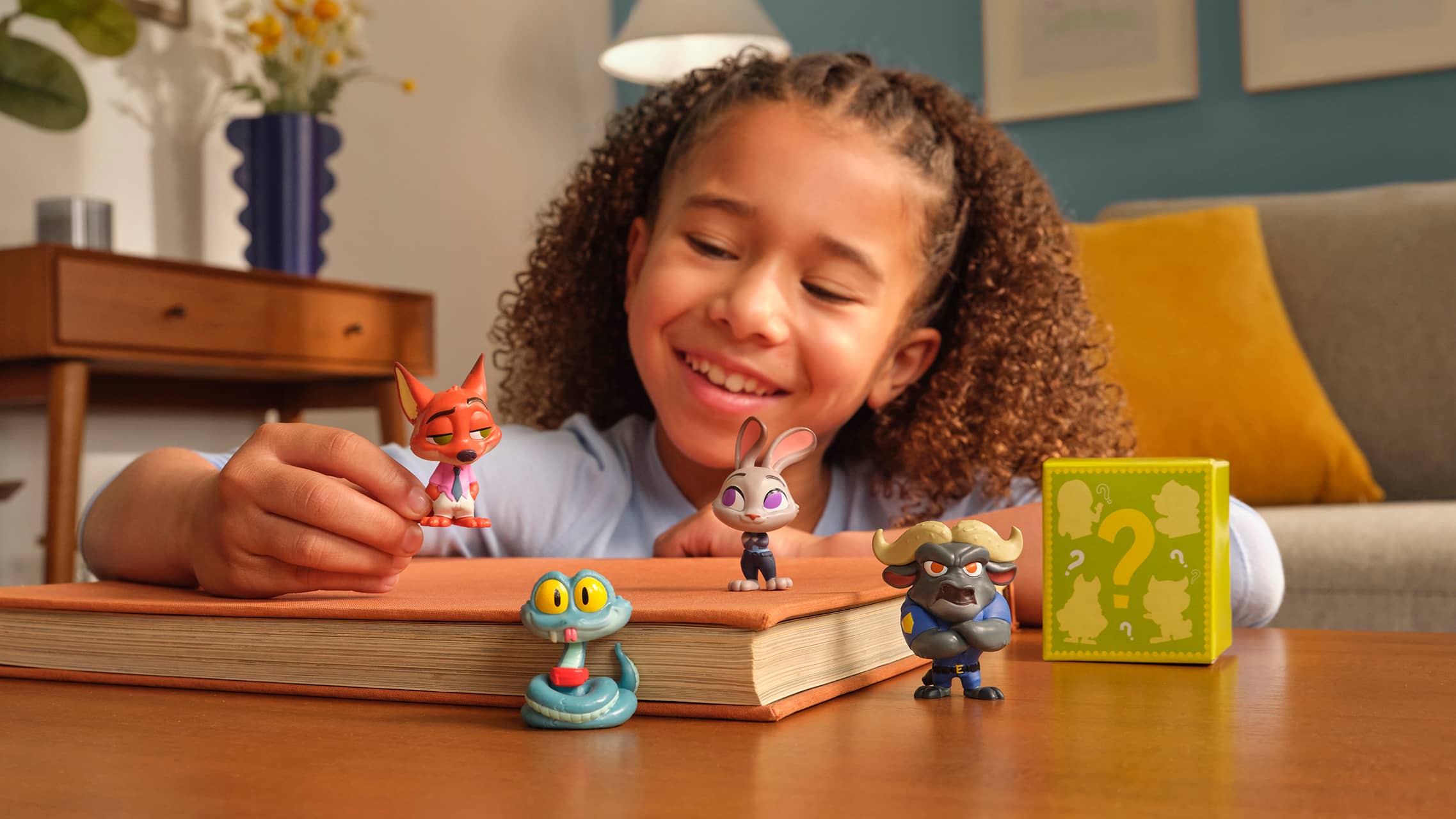 Child playing with Zootopia character toy figures including Nick Wilde and Judy Hopps