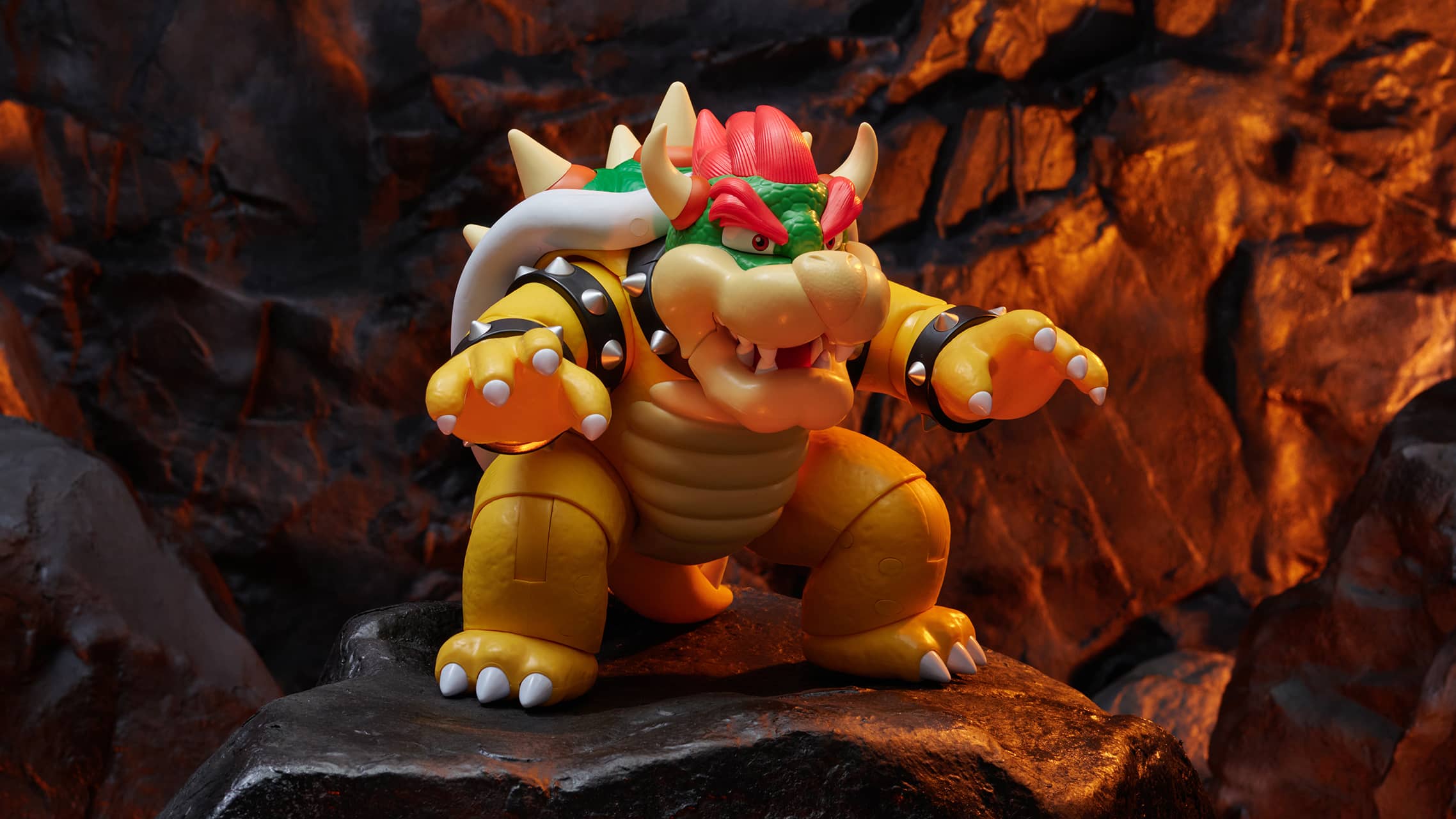 Bowser action figure from Super Mario posed in lava themed rocky environment