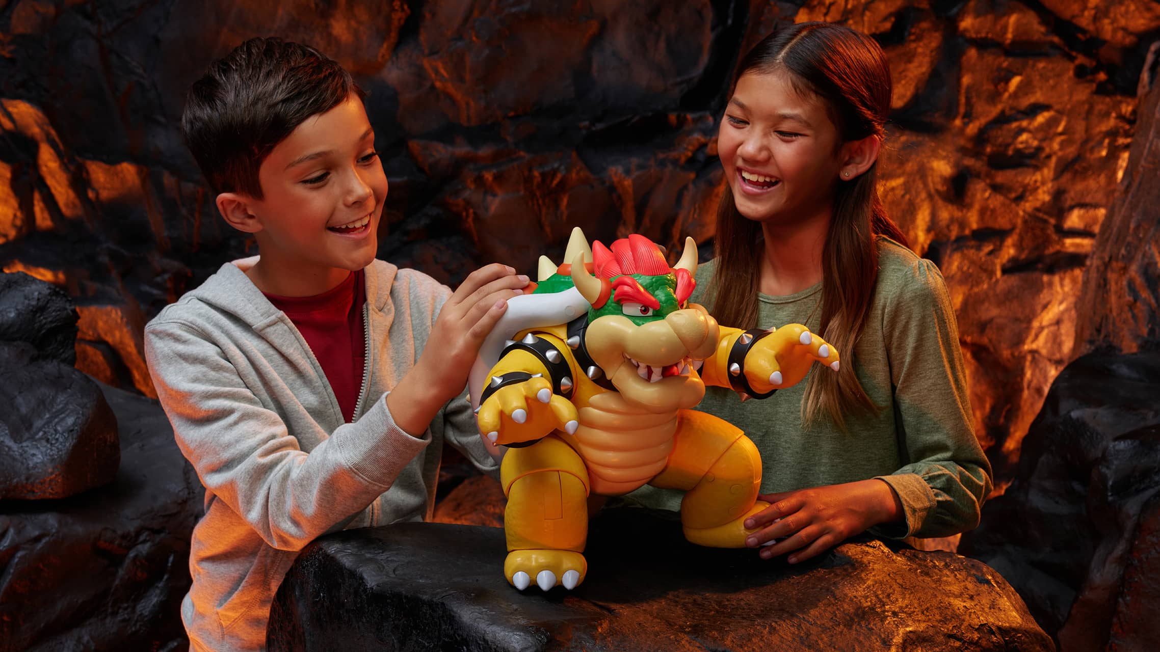 Kids interacting with large Bowser action figure toy from Super Mario