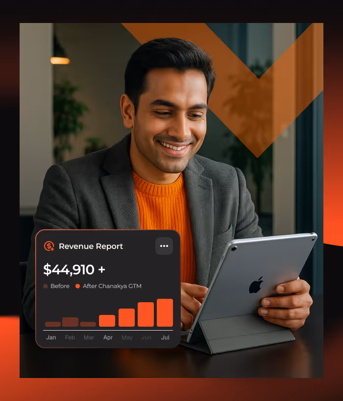 Smiling man in gray blazer and orange sweater using a tablet with a graphic overlay showing a revenue report of $44,910 and a bar chart from Jan to Jul.
