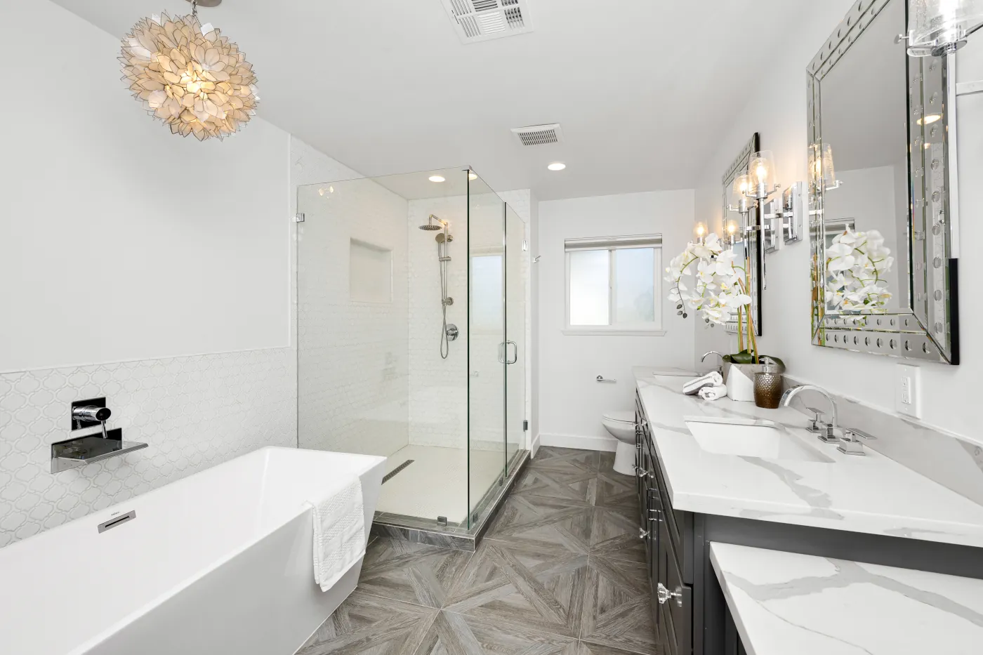 the modern bathroom has wooden floors and marble