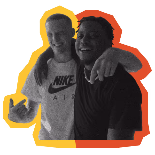 Two young men smiling and hugging; one wearing a Nike Air shirt and the other wearing a black shirt with a chain necklace, with a yellow and red outline around them.