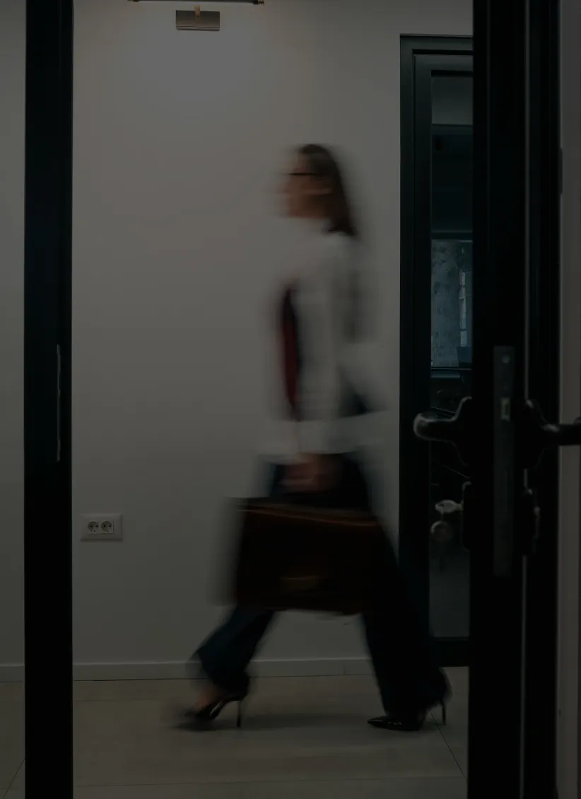 Mist-covered hills under a purple and pink sunset sky.