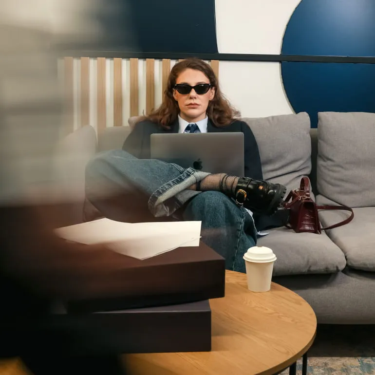 Close-up of a laptop keyboard and trackpad illuminated with purple and blue lighting.