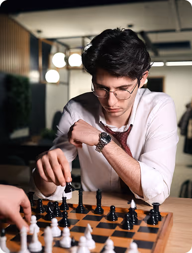 Three people working at a large desk with computers in a modern office space.