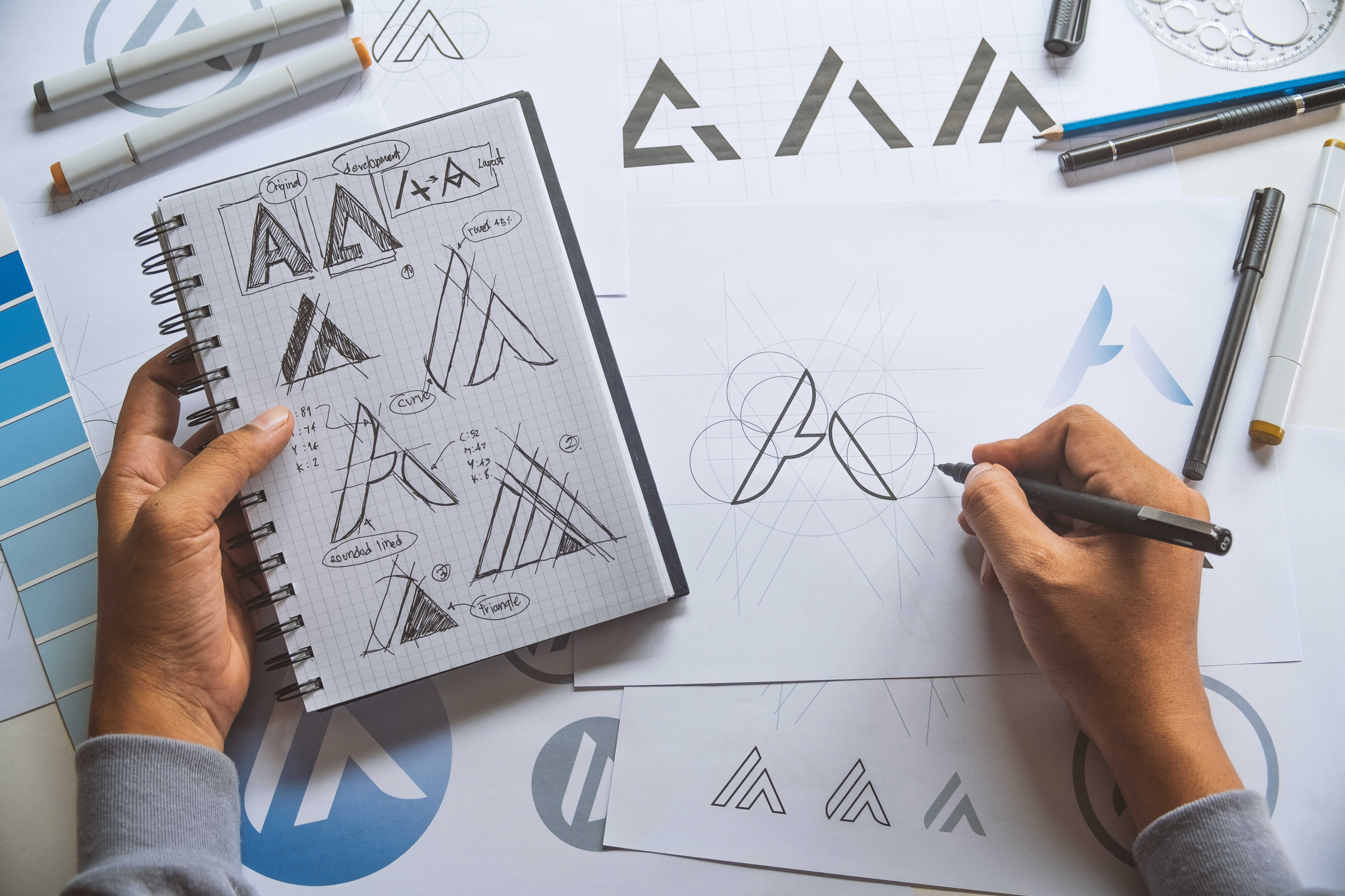 A designer utilizing a creative practice to iterate on logo designs. 
