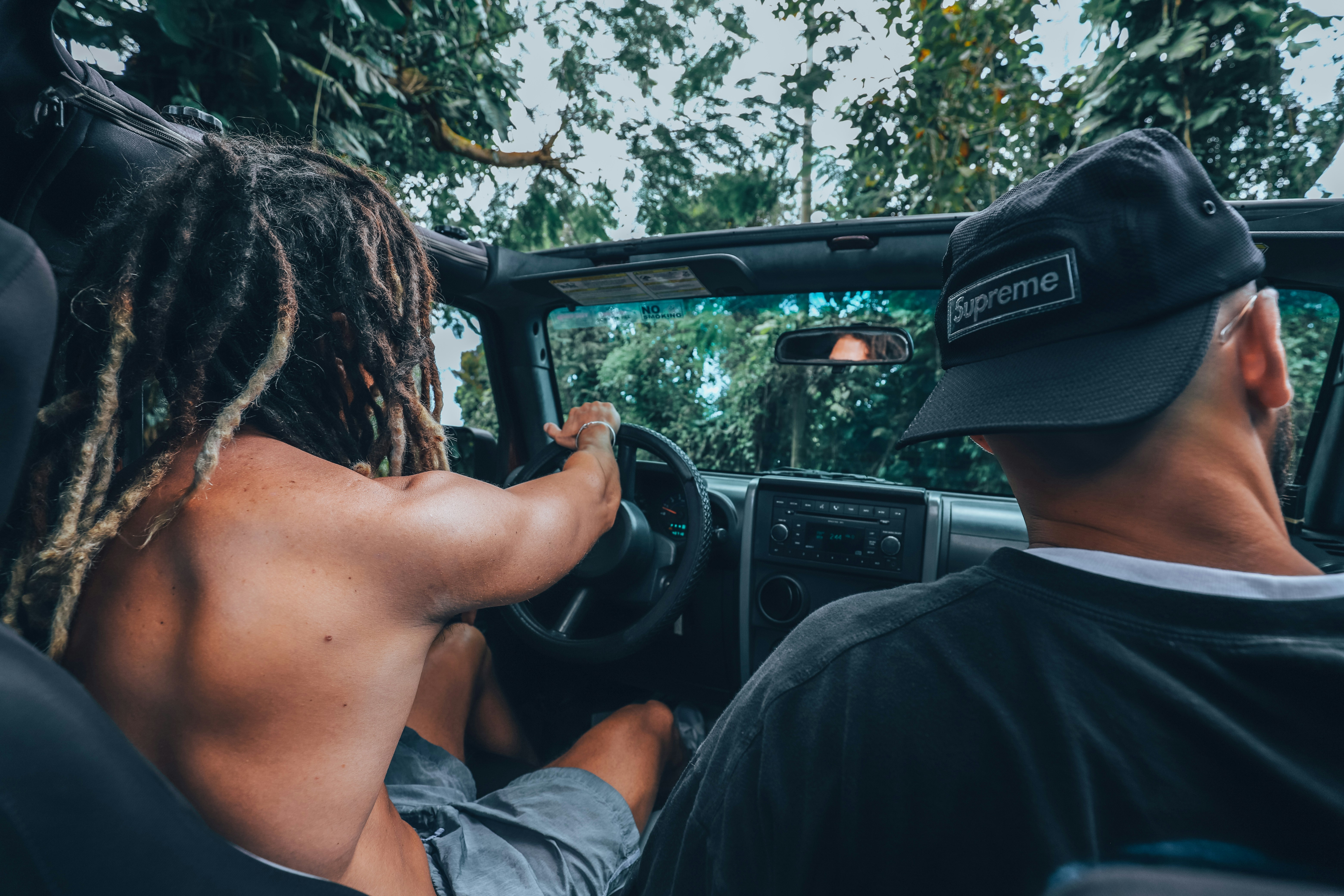 Adventurous couple exploring St. John by Jeep through lush tropical roads in Cruz Bay.