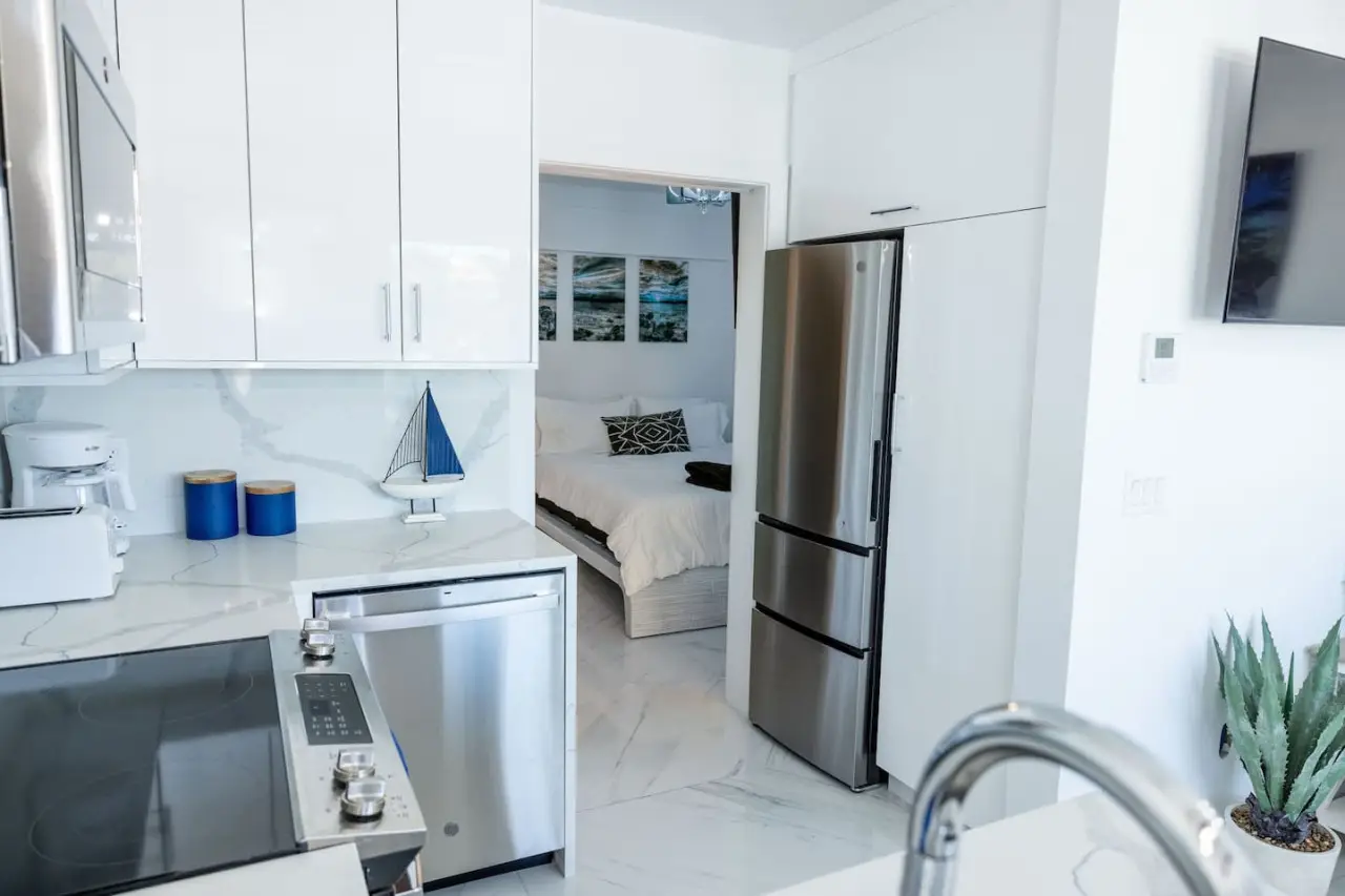Modern kitchen with stainless appliances and bedroom view in Dolphin Suites Unit 6 DGMI St. John.