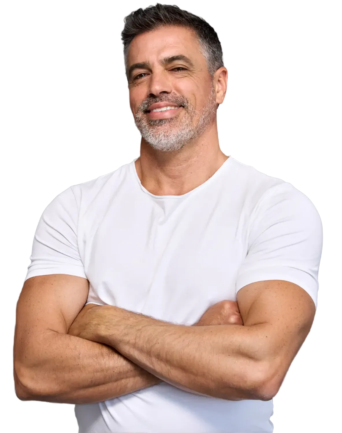A confident middle-aged man with salt-and-pepper hair and a trimmed beard, wearing a fitted white T-shirt, stands with his arms crossed while smiling.