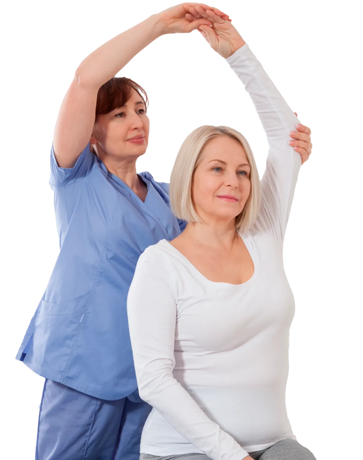 A healthcare professional wearing blue scrubs assists a seated woman in a white long-sleeve shirt by gently stretching her arm overhead.