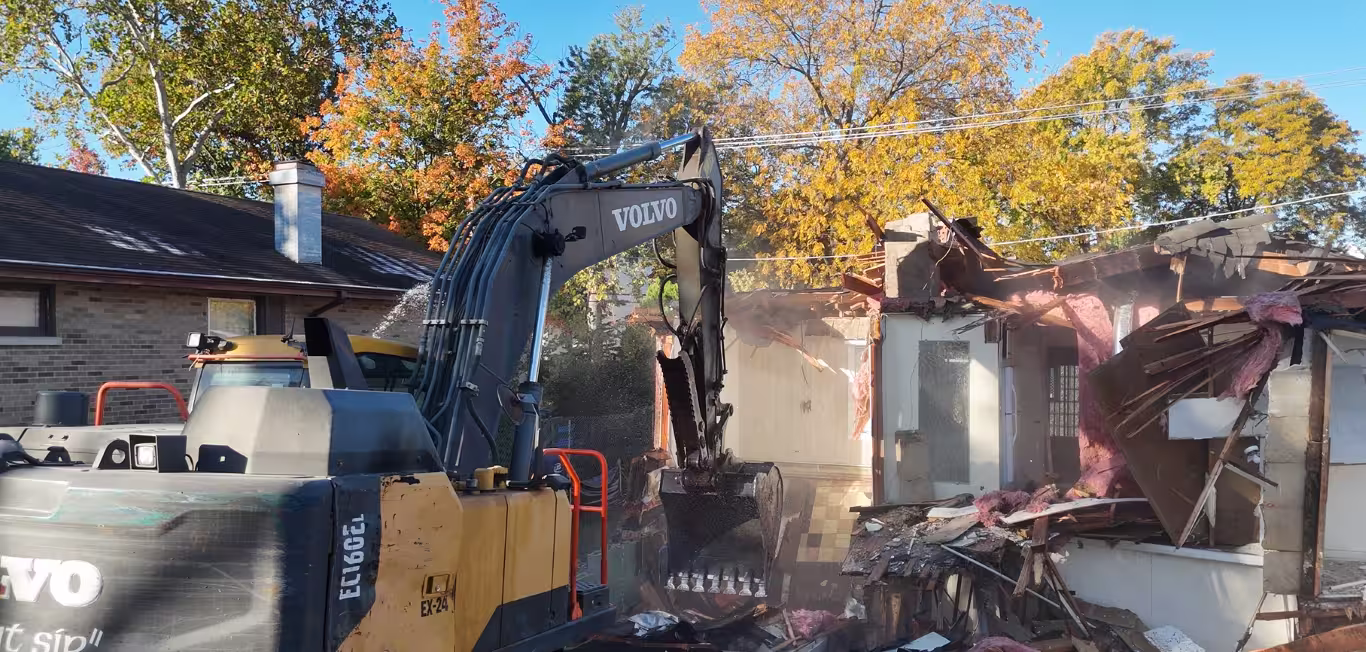 Volvo excavator completing residential demolition by Donegal Services during fall in Chicagoland.
