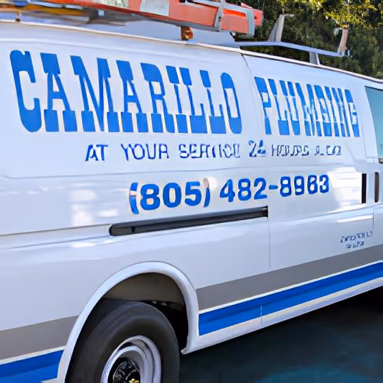 White plumbing service van with blue lettering reading 'Camarillo Plumbing, At Your Service 24 Hours' and phone number (805) 482-8983.