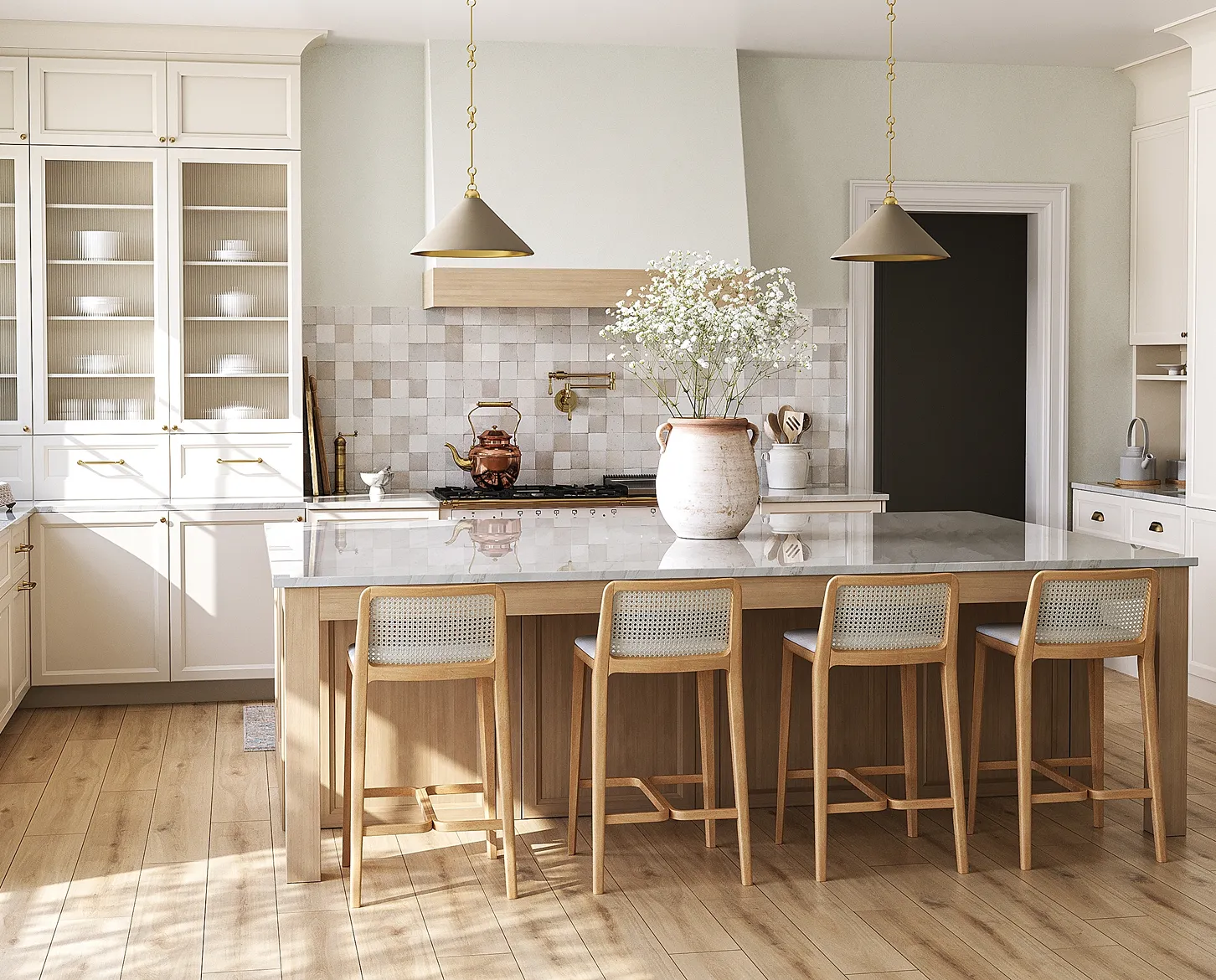 Modern kitchen with white cabinets, a large island with marble countertop, wooden bar stools, and a vase with white flowers.