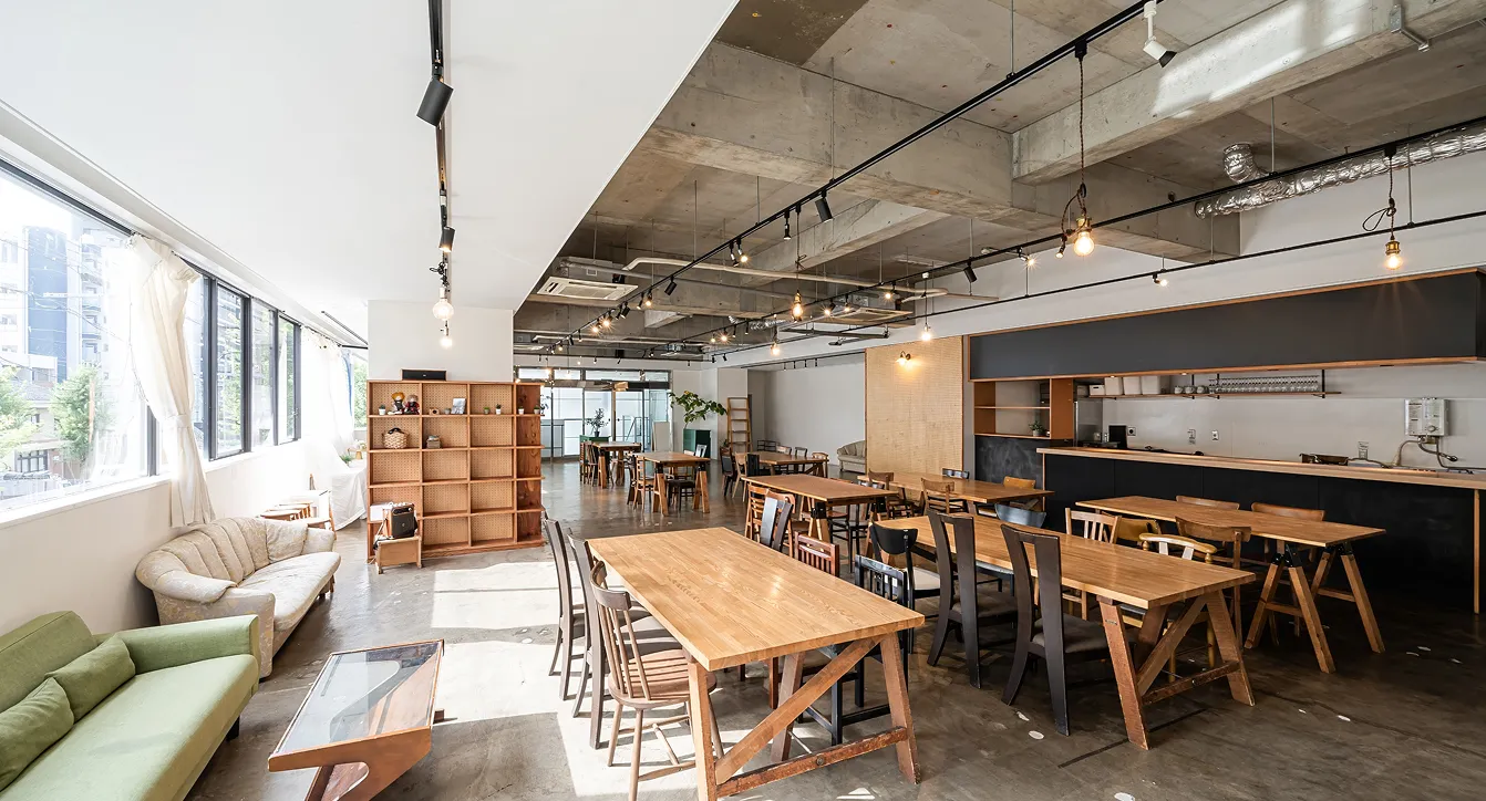 Modern renovated open-concept café with exposed ceilings and natural light.