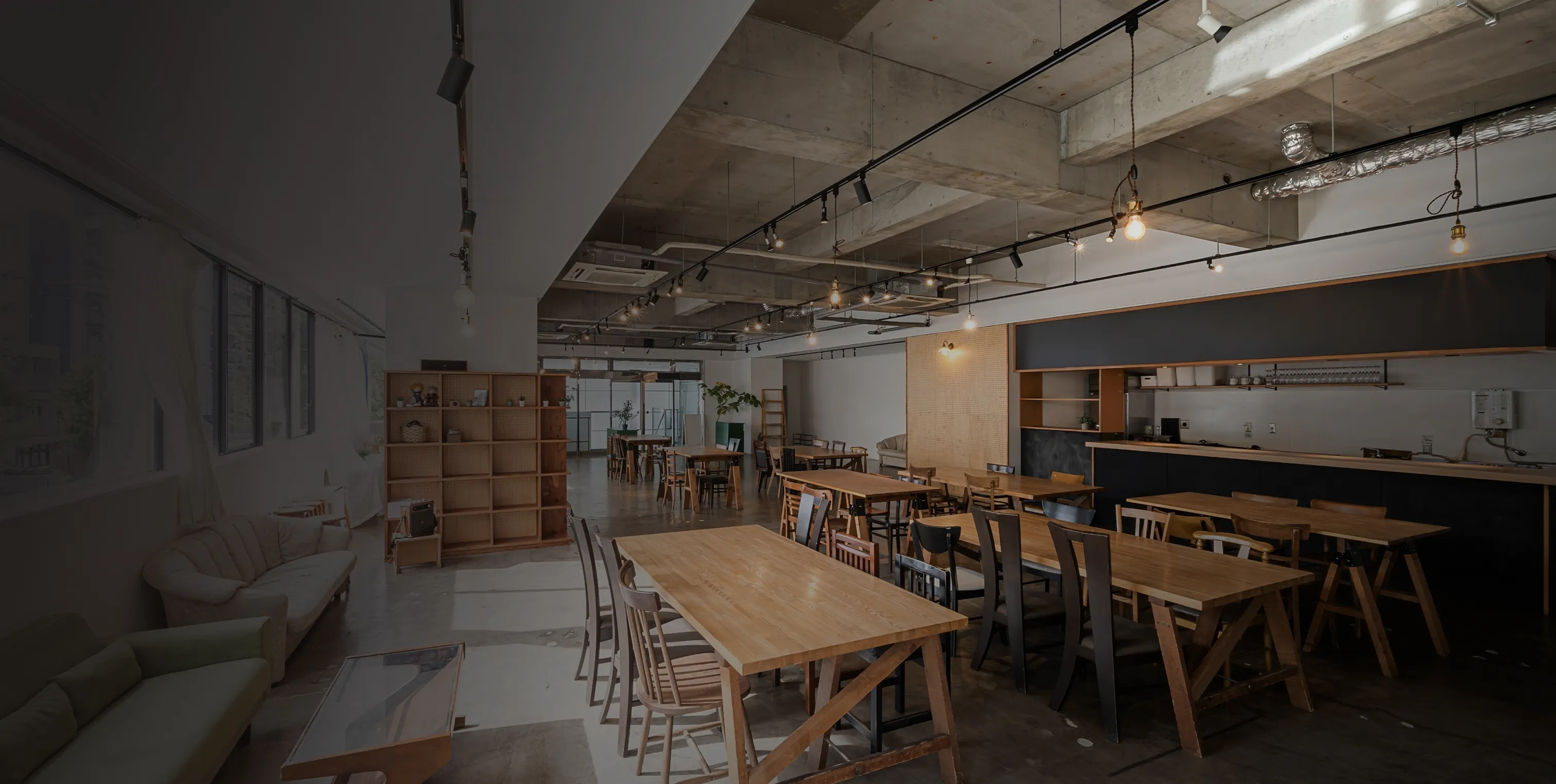 Modern renovated open-concept café with exposed ceilings and natural light.