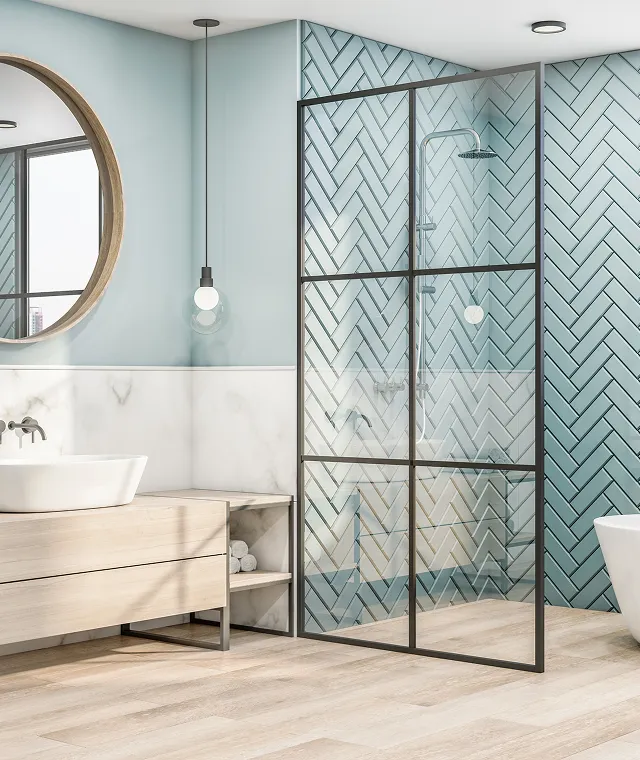 Bright bathroom featuring teal herringbone shower tile and wood vanity from a recent renovation.