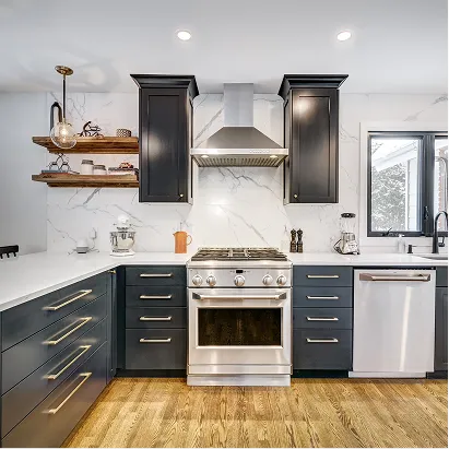 Sleek kitchen remodel with black cabinets, marble backsplash, and stainless-steel appliances.